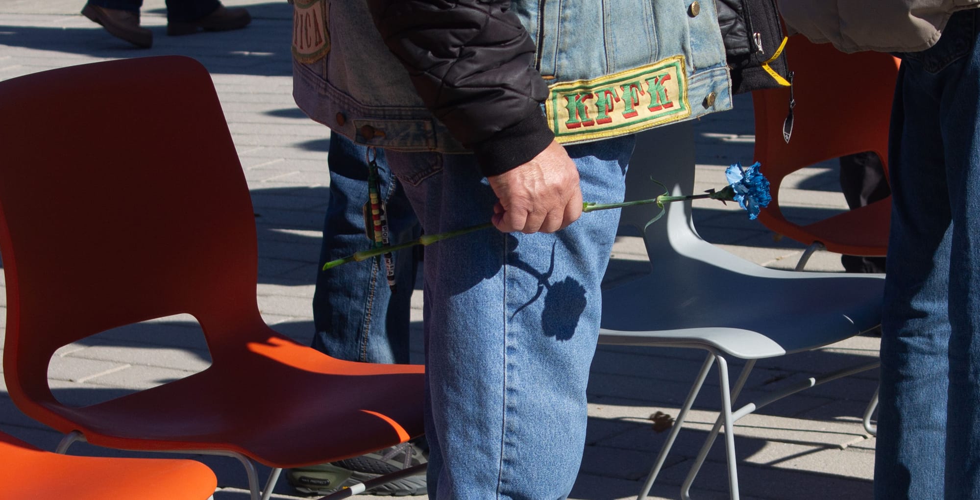 A member of the Nam Knights group holds a blue rose.