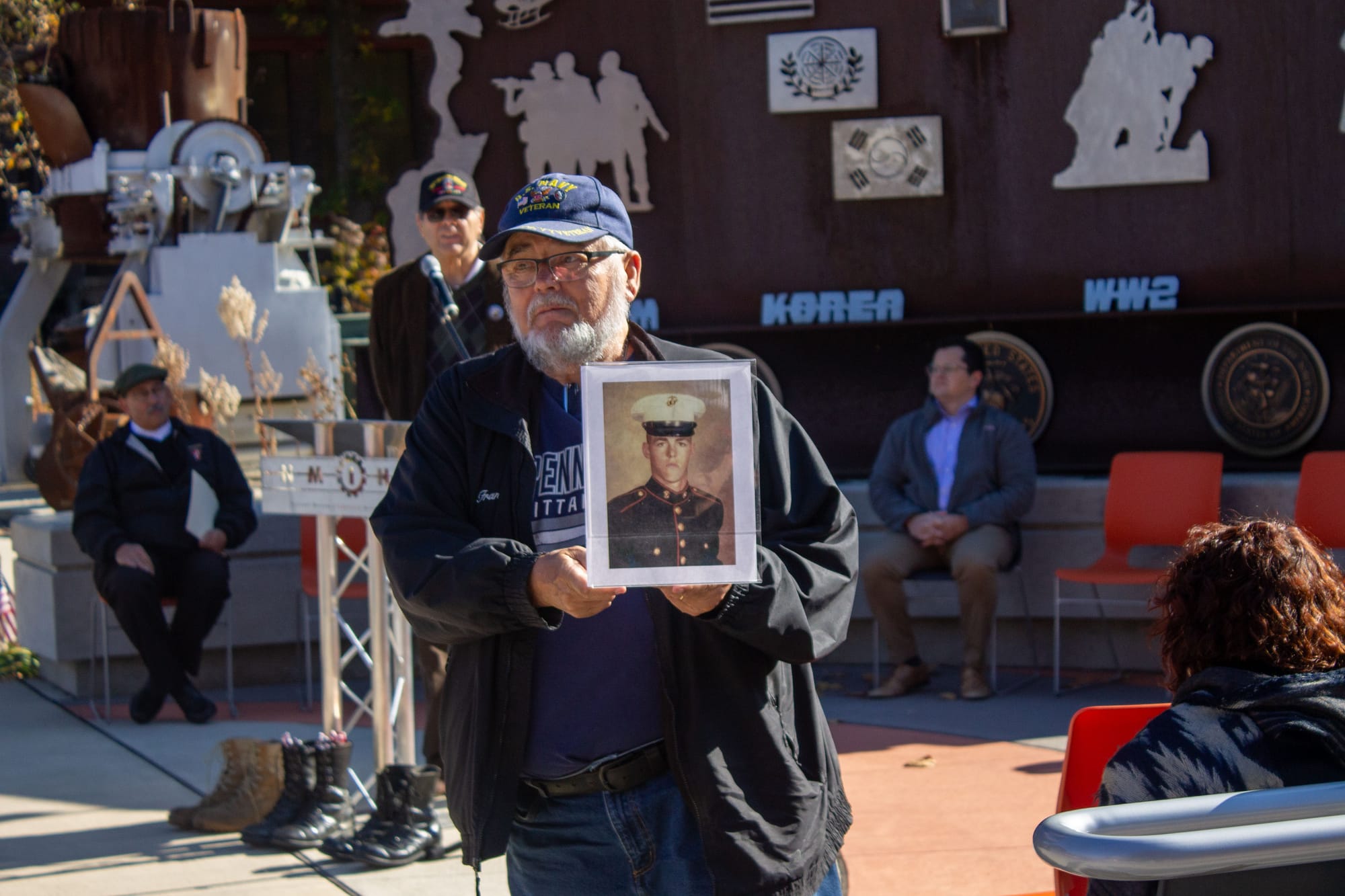 One of the organizers of the event holds up a photo of a fallen soldier while he is commemorated.