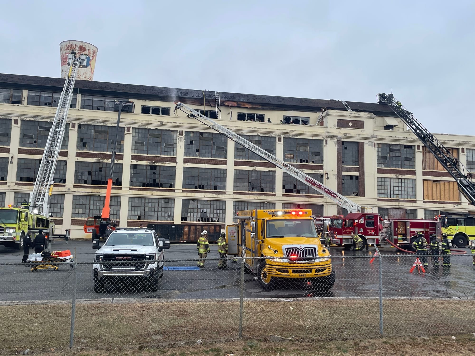 Firefighters respond to the old Dixie Cup factory in Wilson Borough on Friday morning.