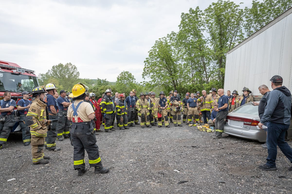 Ken Sobieski (center, sitting on car) talks with firefighters at a training event in Palmer Township on May 25, 2023.