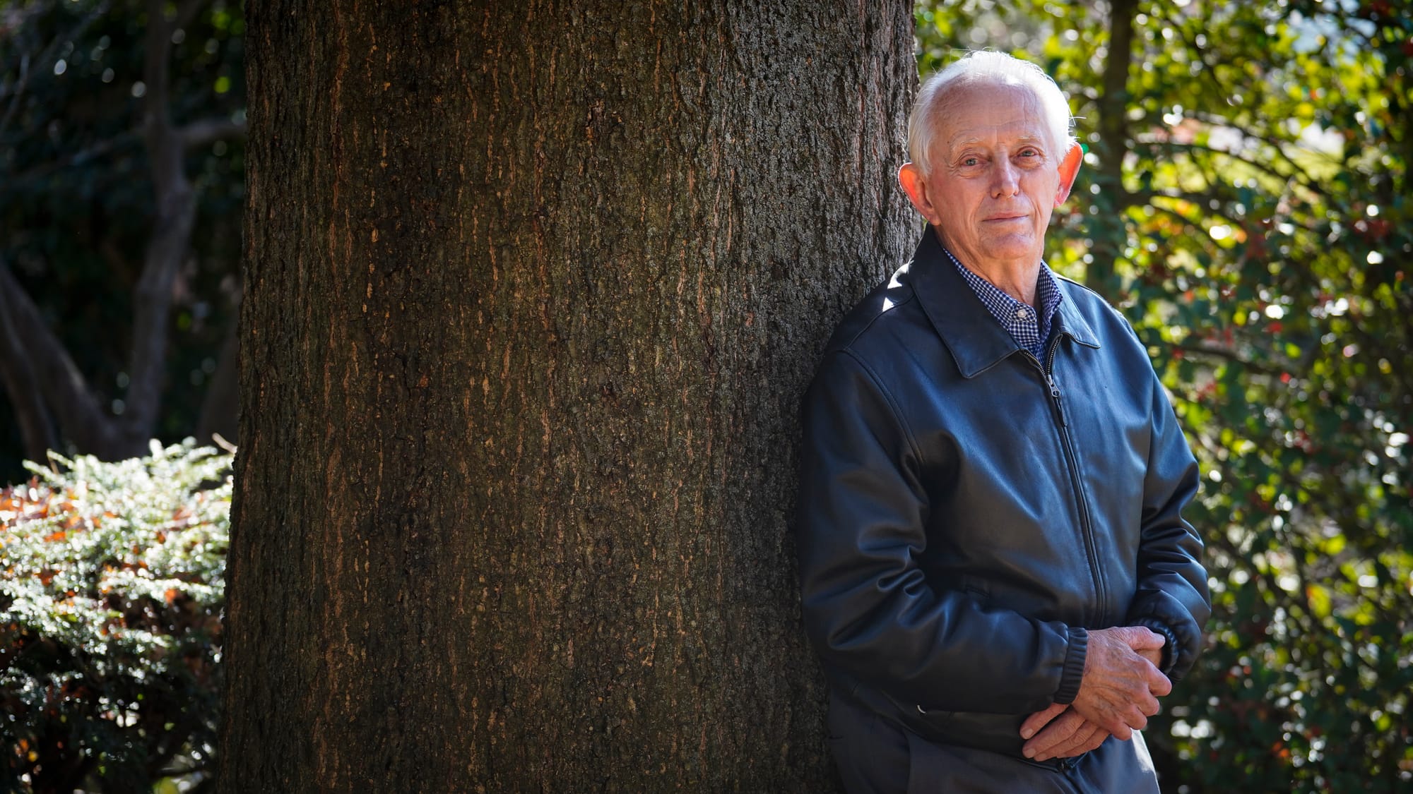 Fred Buse leans on a pin oak tree he planted in the early 1980s. Fred Buse, 87, of South Whitehall Township, has been trackin