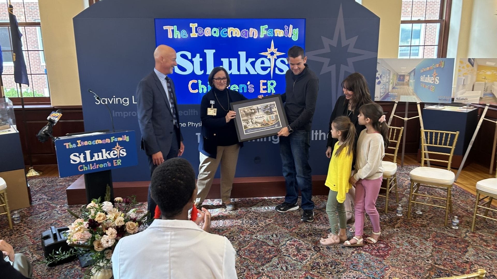 The Isaacman family accepts a plaque at the announcement of St. Luke’s University Health Network's Isaacman Family Children’s