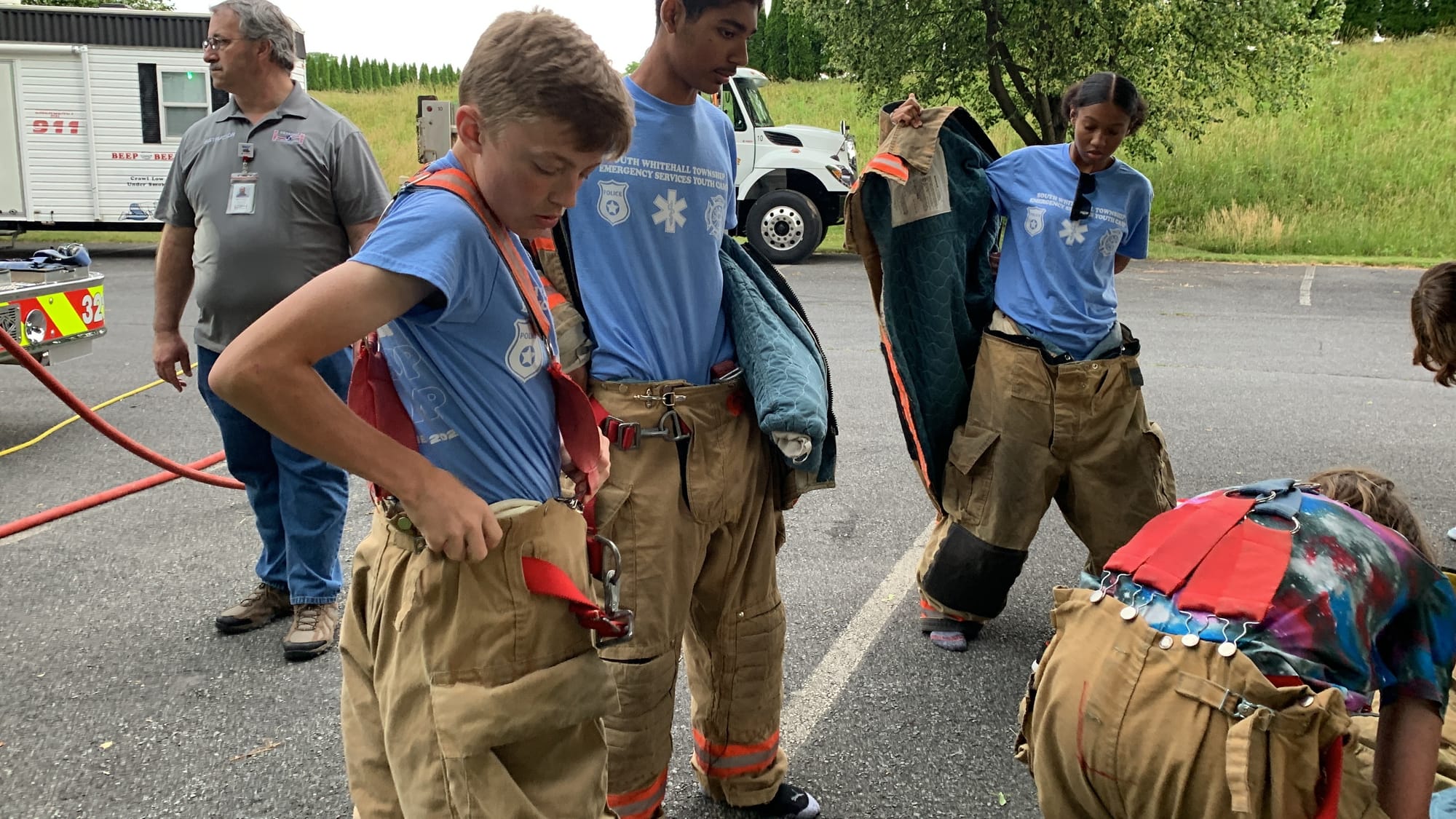 Camp attendee Jackson Deily puts on his firefighting gear.