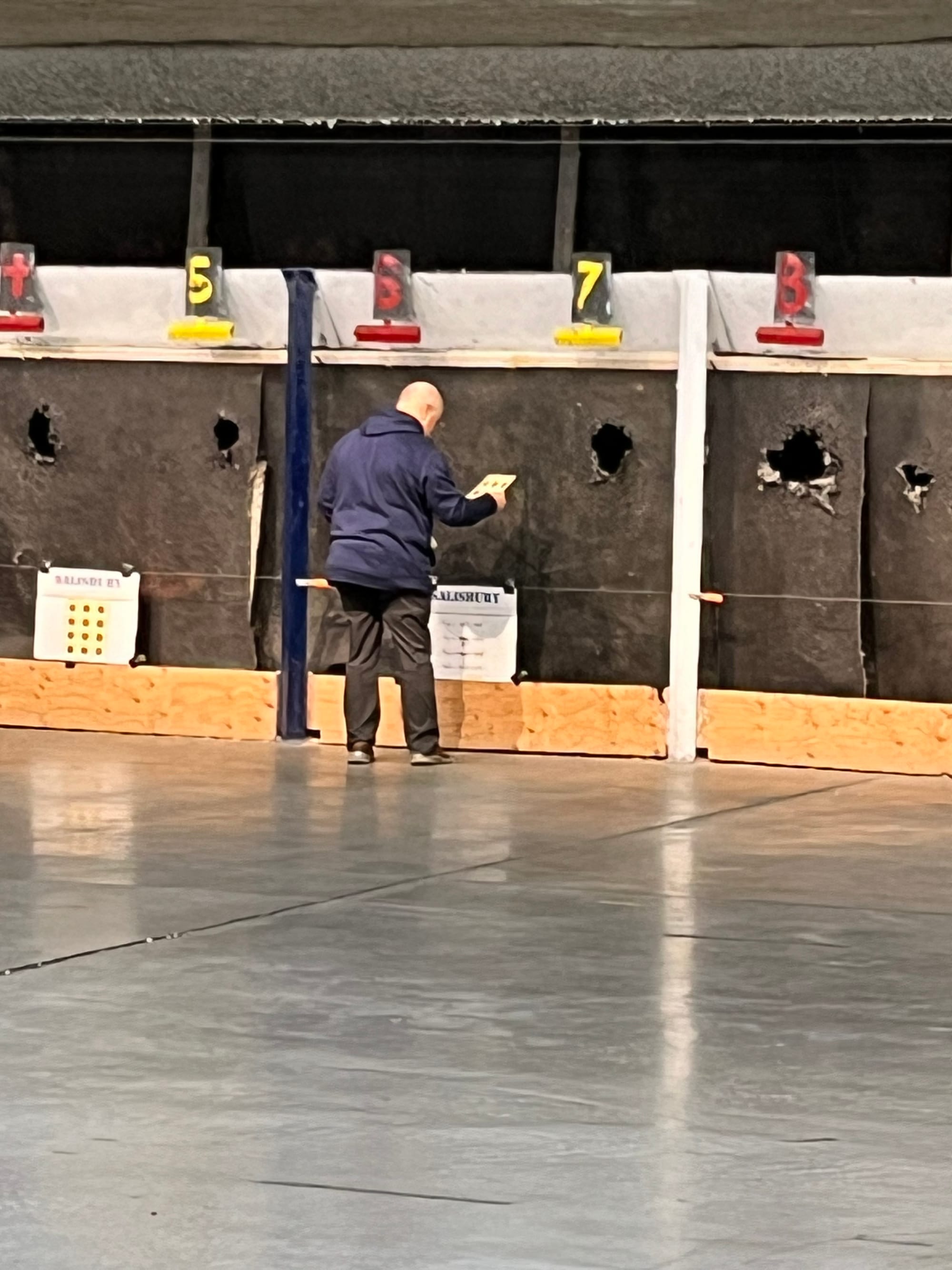 Salisbury High School coach Mike Pennella sets up a target for one of his athletes during the Falcons' match against Southern