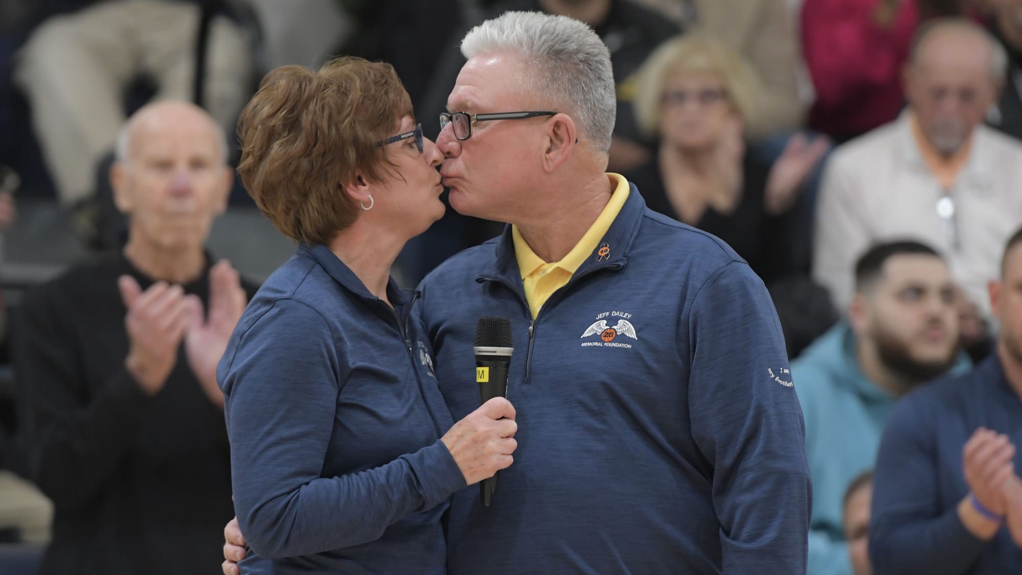 Jane Dailey kisses her husband Bobby during a court dedication for Jeff Dailey on Friday, December 1, 2023, at Notre Dame-Gre