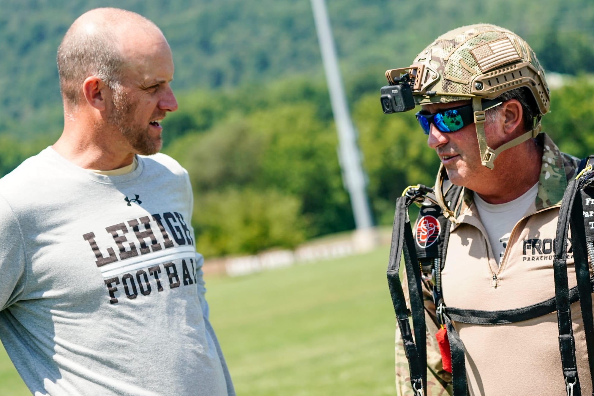 Lehigh football coach Kevin Cahill, left, talks with Marc Hogue. U.S. Special Forces members including U.S. Navy SEALs skydiv