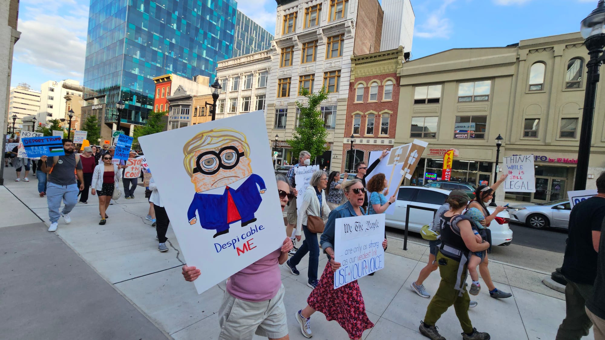 Protesters walk down Hamilton Street toward U.S. Rep. Ryan Mackenzie's office Thursday, May 1.