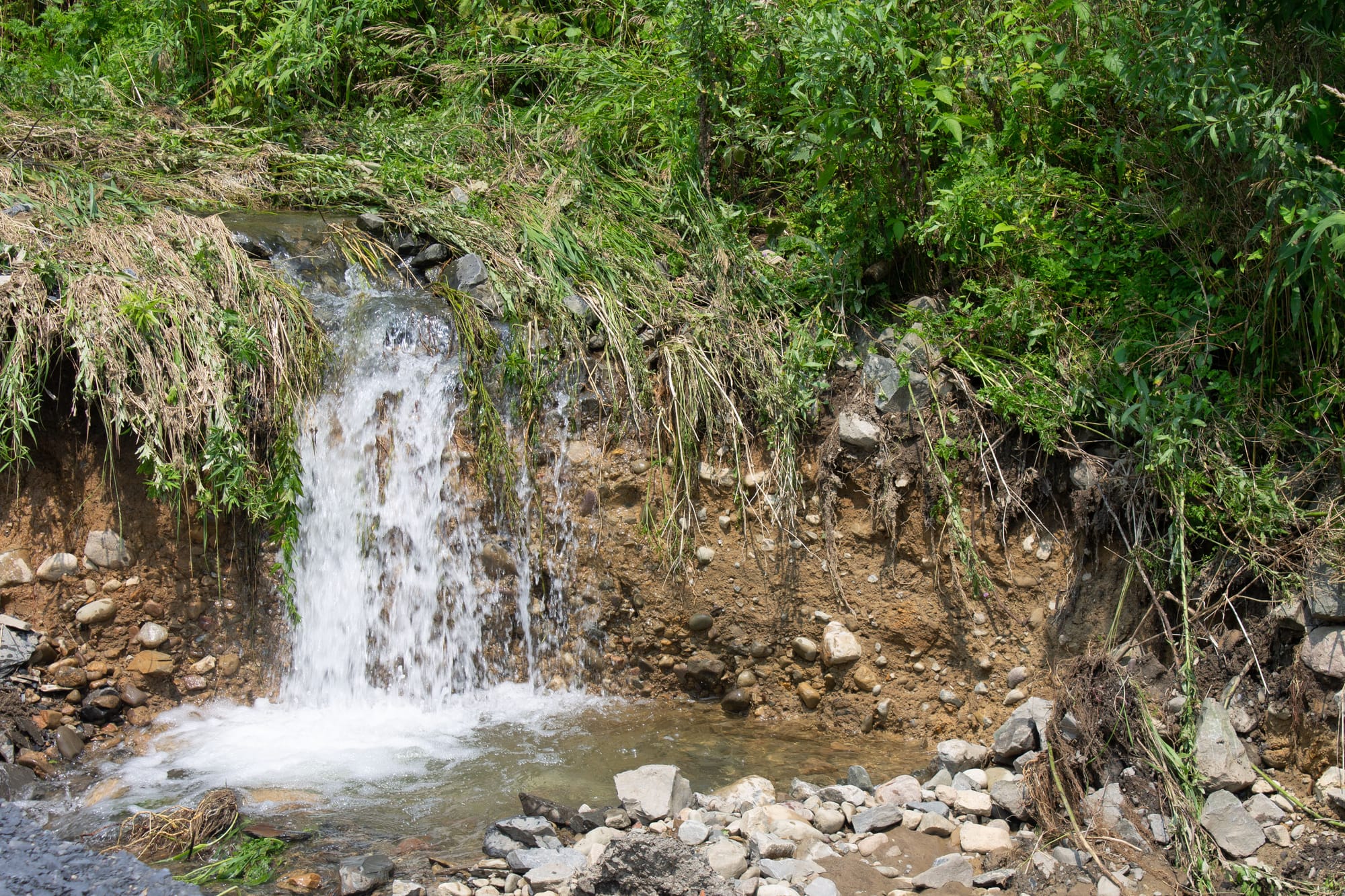 This scene, which looks like a waterfall, did not exist until recent floods. The water eroded a section of the land and creat
