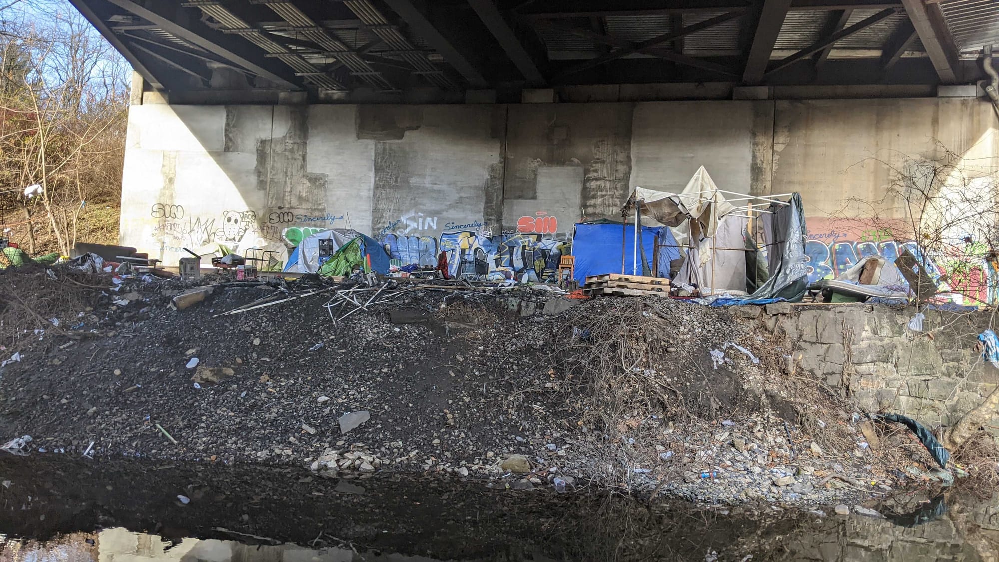 Police say two adult men were found with burns to their arms and hands following an early morning fire at an encampment under