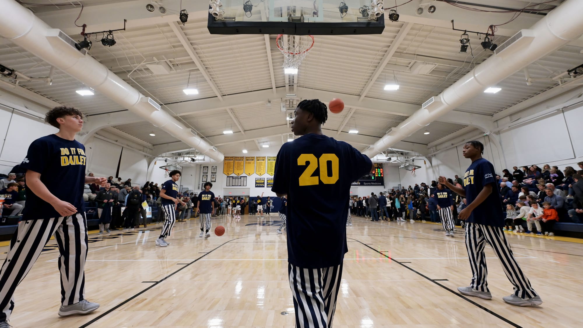 Players warm up before a court dedication for Jeff Dailey on Friday, December 1, 2023, at Notre Dame-Green Pond High School.