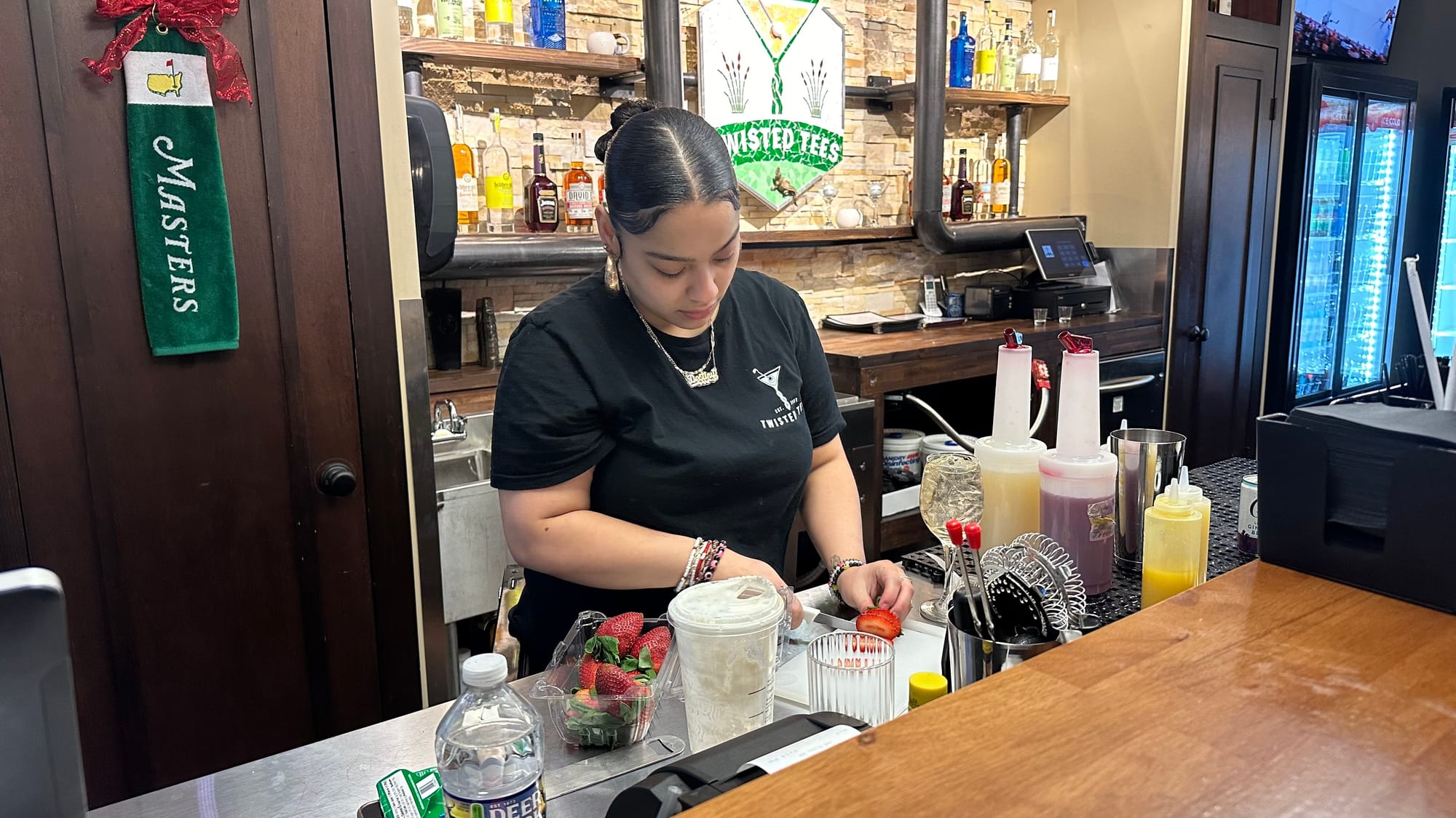 A Twisted Tees bartender prepares drinks during their grand opening celebration on Saturday, January 27.
