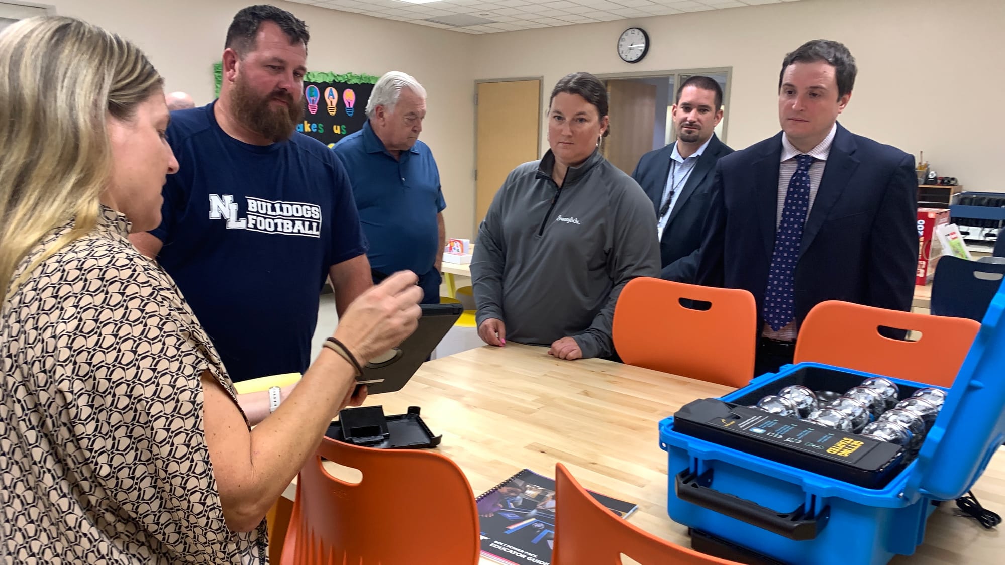 SHINE teacher Michelle Siesko demonstrates one of the programs in the makerspace to members of the Northern Lehigh School Boa