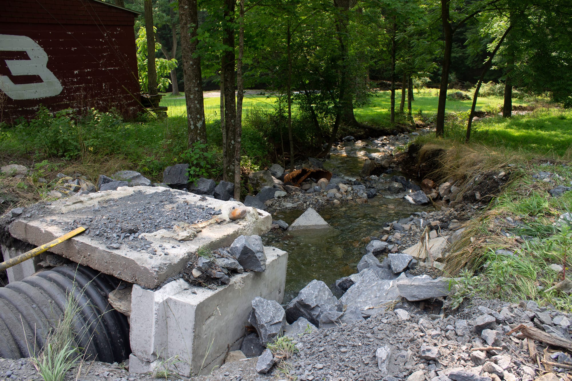 This pipe was once covered with rocks and land, but floods washed it away, leaving it bare.