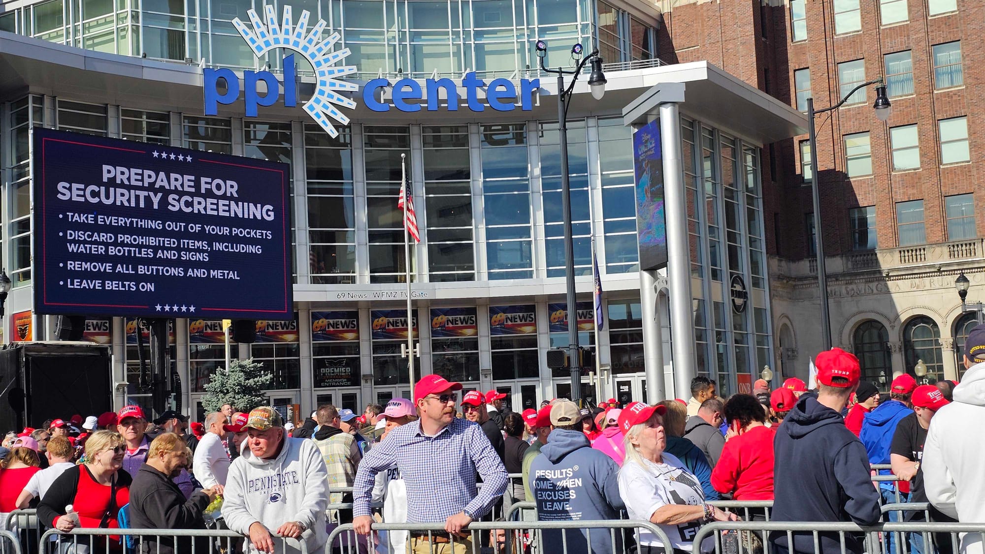 Trump rally-goers wait in the labyrinth in downtown Allentown, underneath specific security screening instructions.