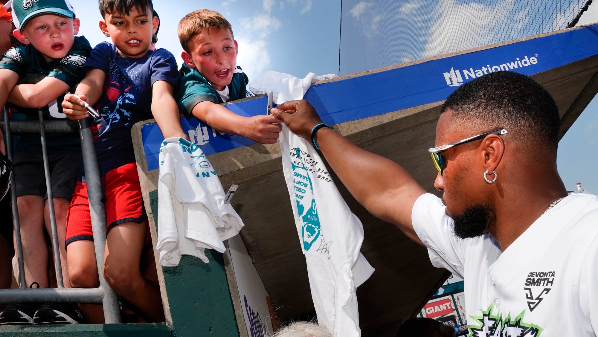 Saquon Barkley of the New York Giants autographs a tee-shirt for a fan Saturday. The 2nd annual Devonta Smith Celebrity Softb