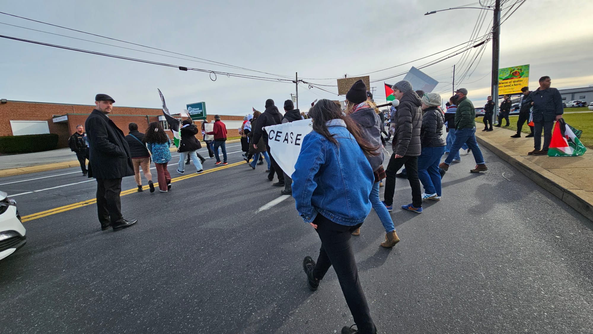 Police escort pro-Palestine protestors across Lehigh Street ahead of President Joe Biden's visit to the Allentown Fire Academ