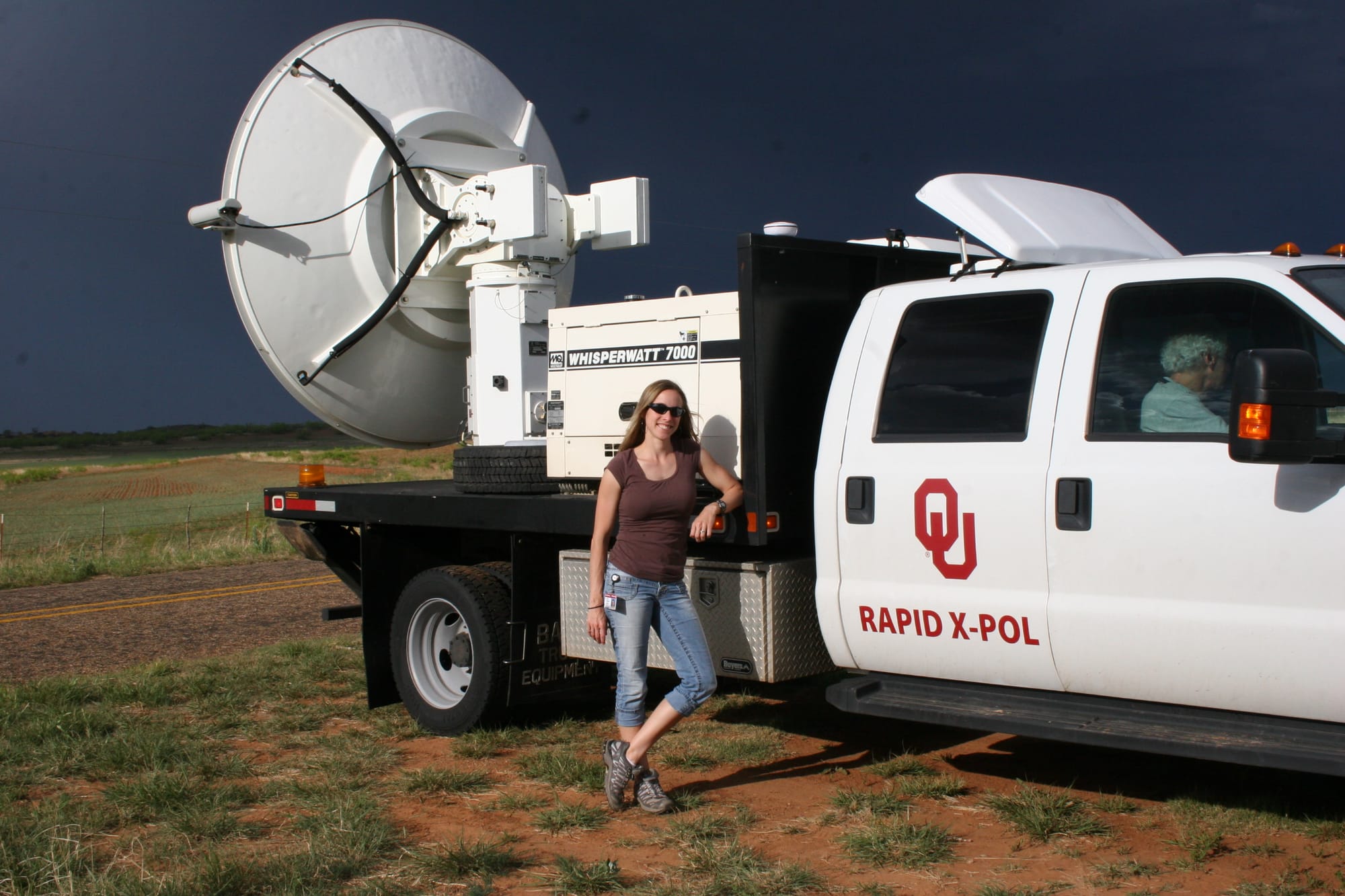 Jana Houser with RaXPol, a mobile research radar designed and operated by the University of Oklahoma.