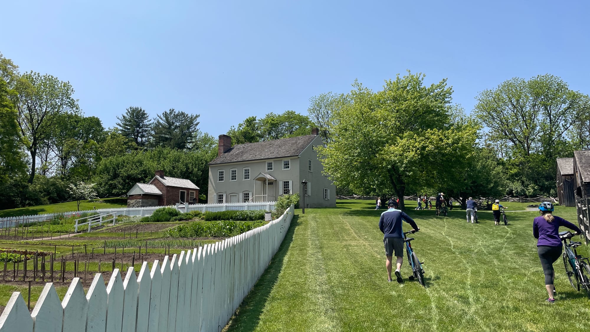 Some folks hop off their bikes to make their way up the grassy hill at Burnside Plantation.
