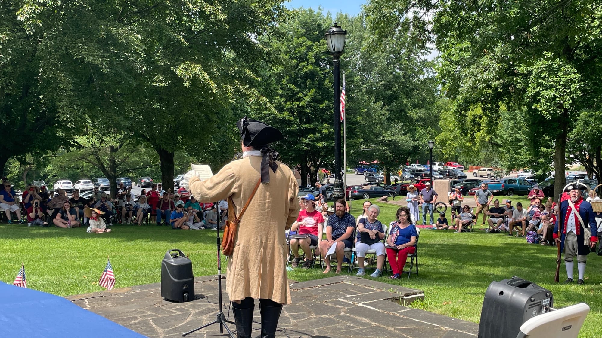Christopher Black, as Robert Levers, reads the Declaration of Independence to the audience gathered to listen.