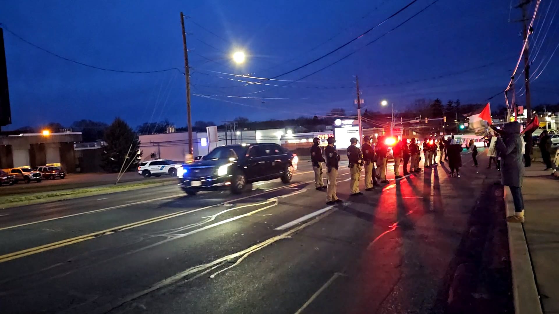 President Joe Biden's motorcade drives past a group of pro-Palestine protestors as he leaves the Allentown Fire Academy on Ja