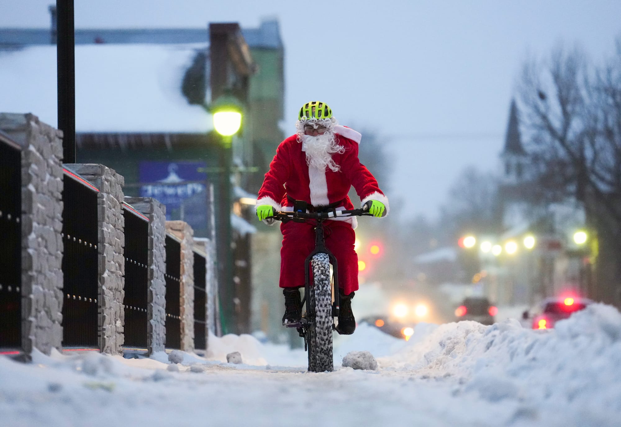 Brian Dickie, dressed as Santa Claus, rides his bike through the wintery streets of Carleton Place, Ontario, Christmas Eve, S