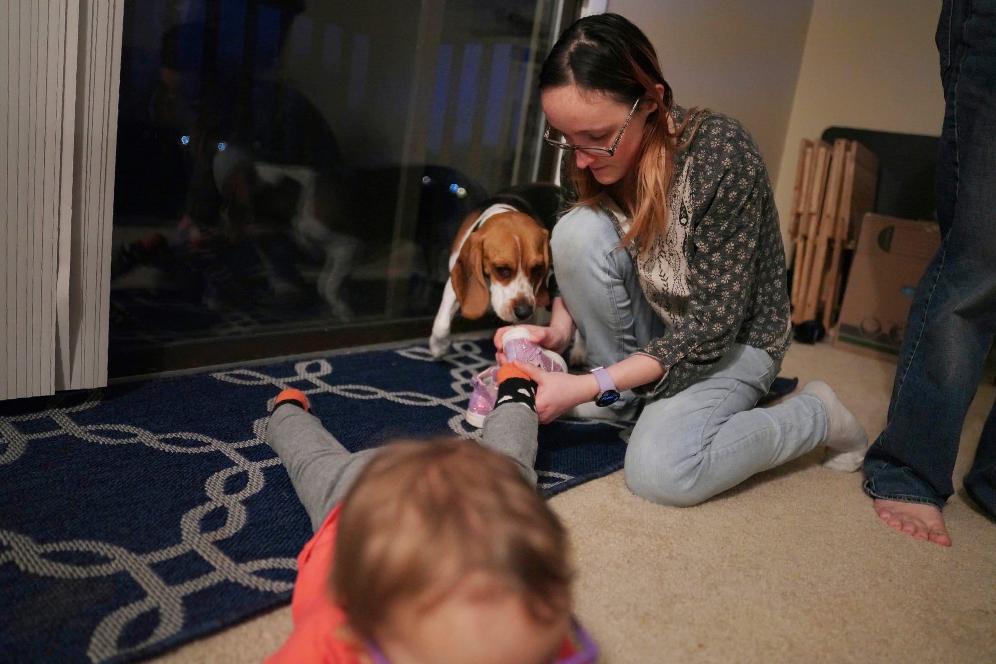 Lauren Hackney puts shoes on her 1-year-old daughter at the end of their twice weekly supervised visits in Oakdale, Pa., on T