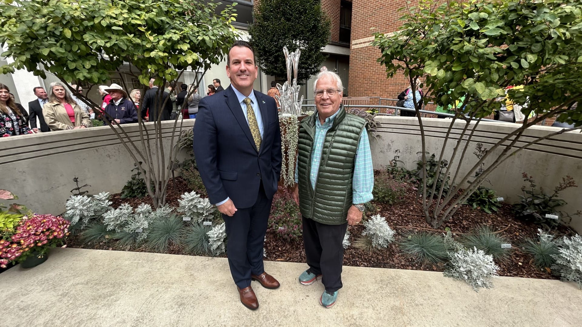 Hospital President Jim Miller and artist Peter Yenawine pose together at the community healing garden at Lehigh Valley Hospit