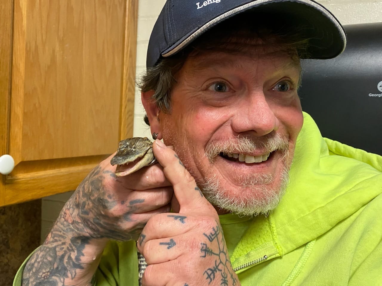 Employee Craig Hill with the alligator he helped rescue.