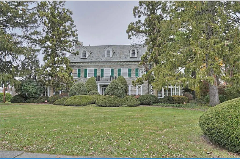 Green shutters and stone walls make this house stand out