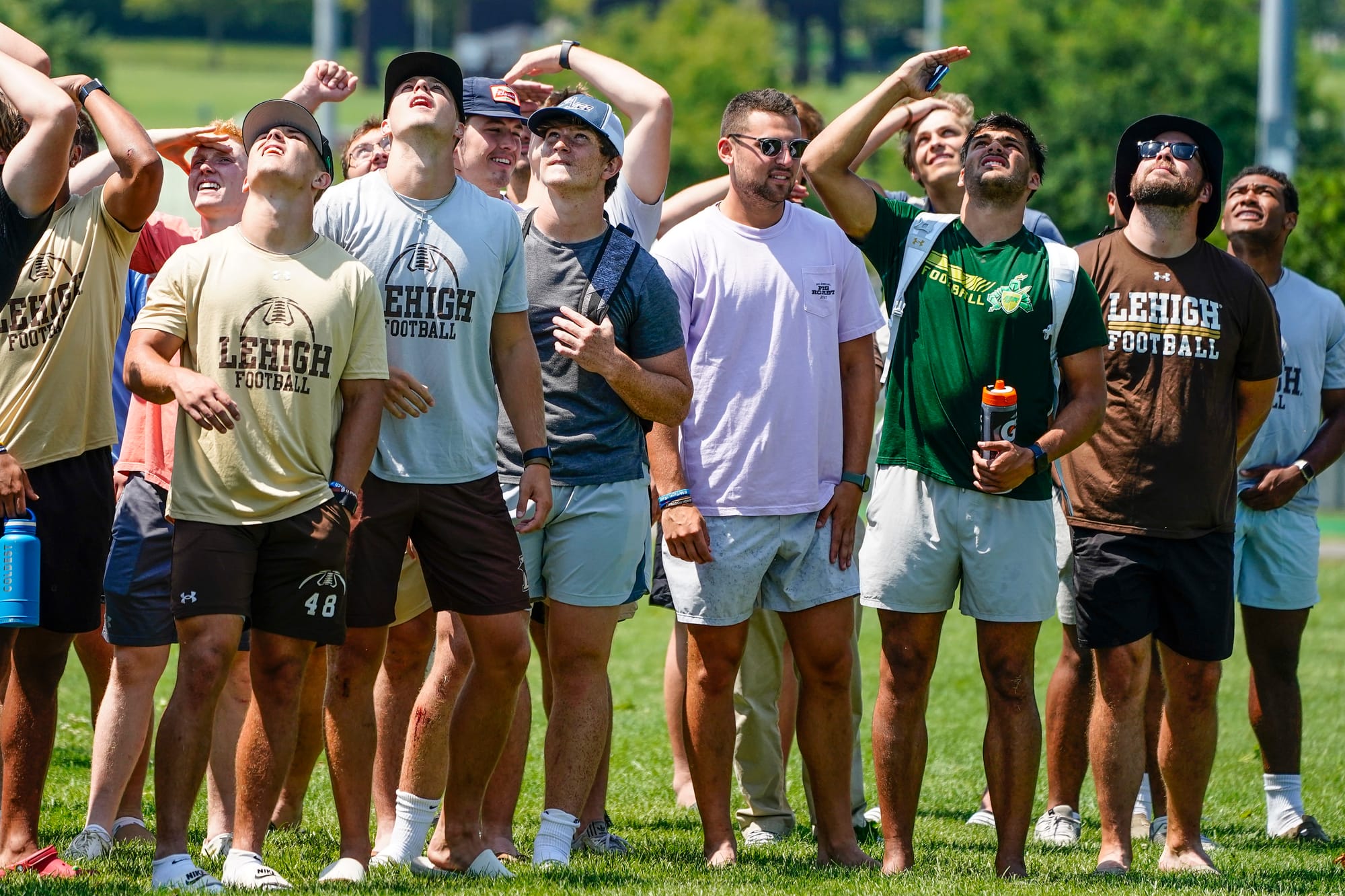 Lehigh football players watch as U.S. Special Forces members including U.S. Navy SEALs skydive from 4,000' onto the field nea