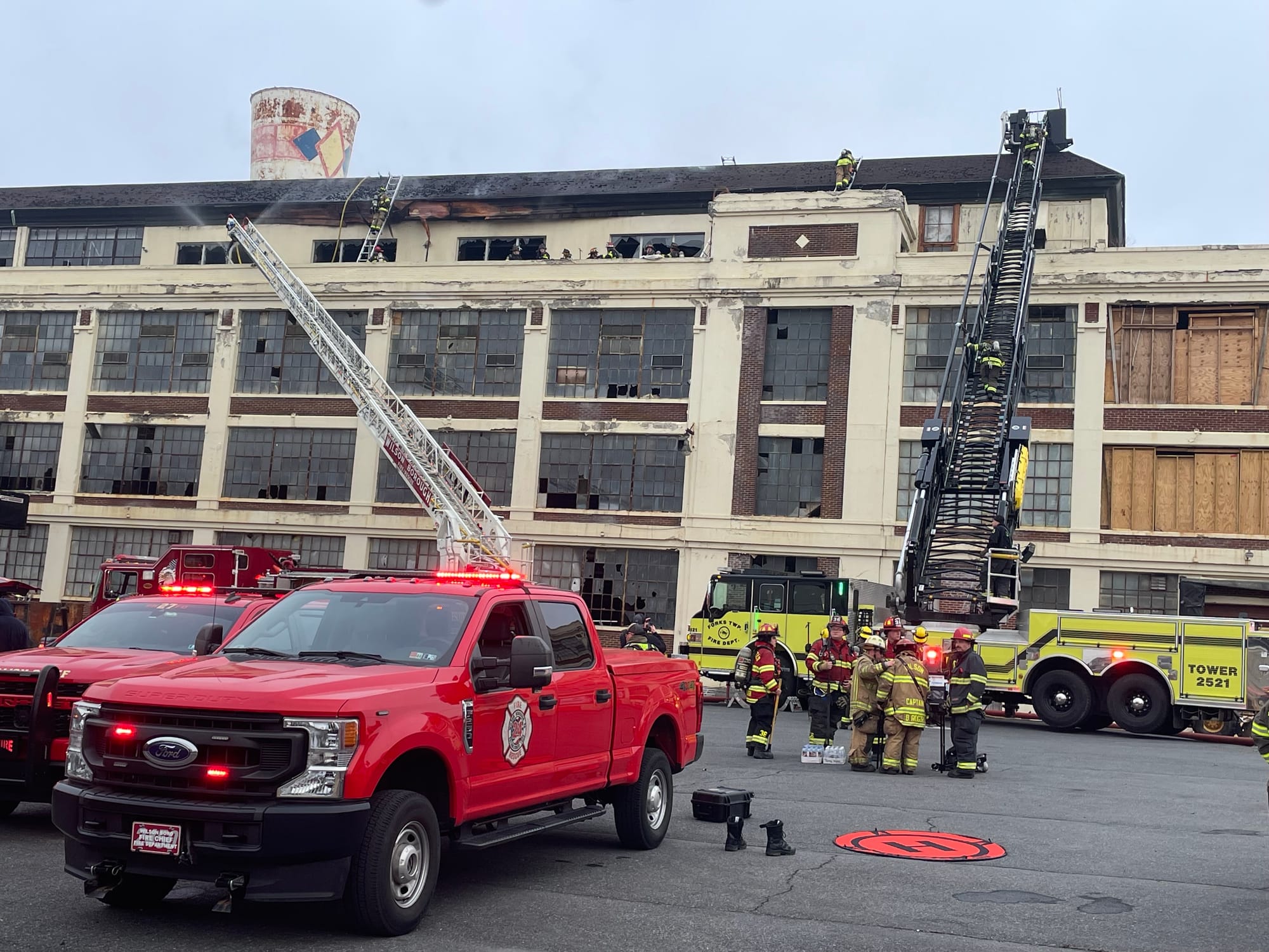 Firefighters respond to the old Dixie Cup factory in Wilson Borough on Friday morning.