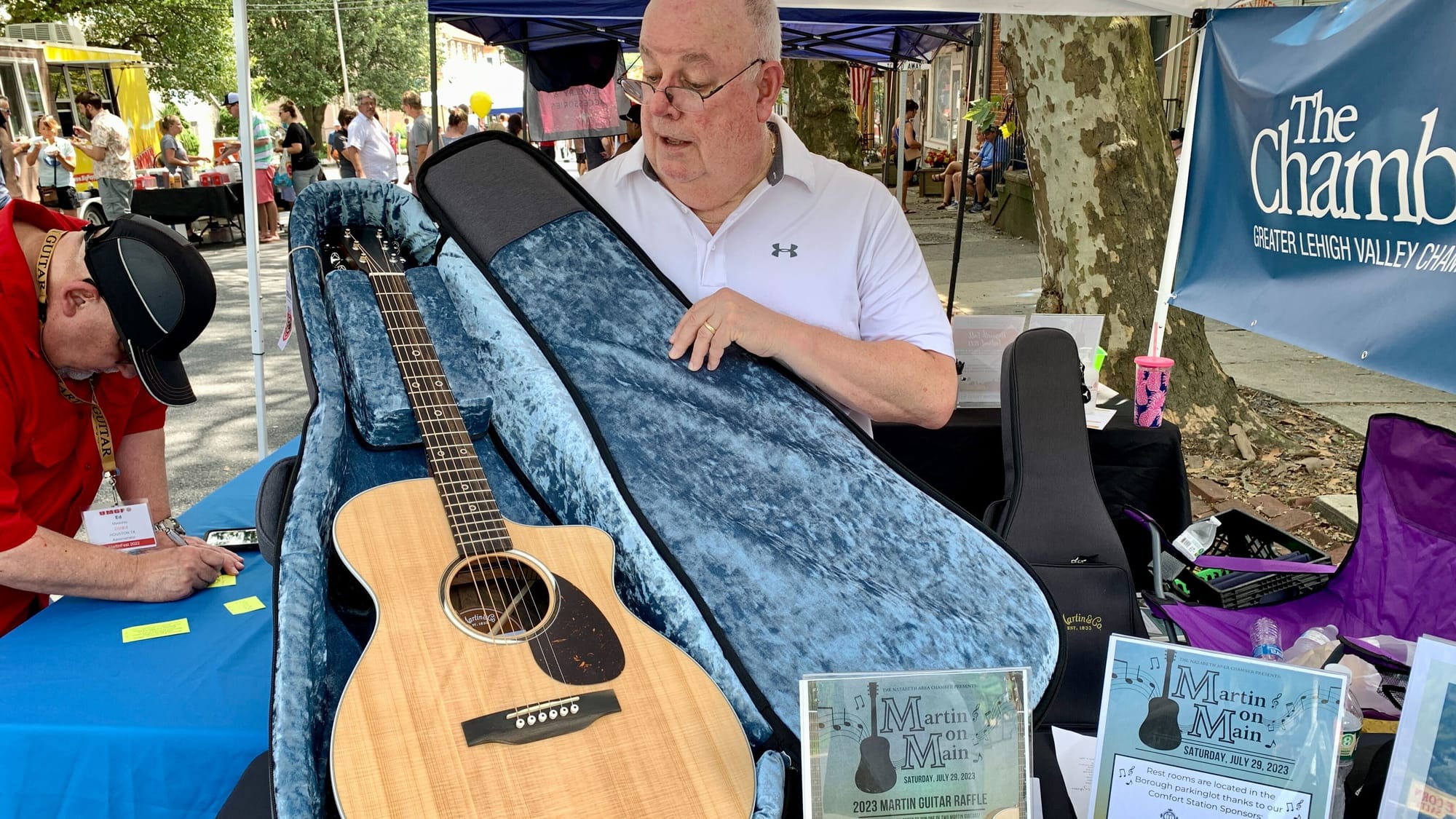 Board member of the Nazareth Area Chamber of Commerce Bill Skinner shows off one of the guitars that was raffled at the event