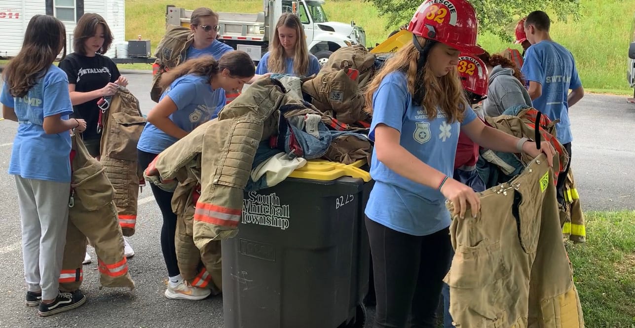 Camp attendees put on firefighting gear.