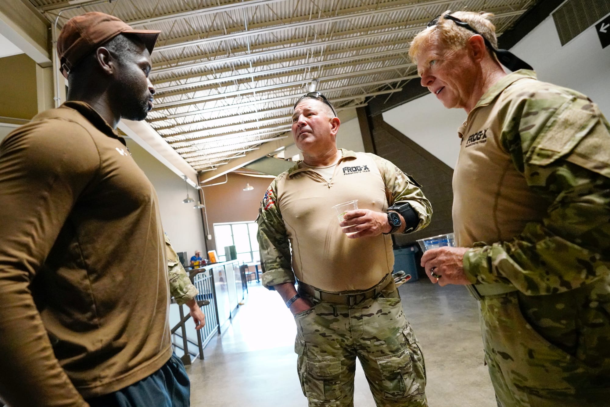 Marc Hogue, center, and Dan O'Toole speak to a Lehigh football player. U.S. Special Forces members including U.S. Navy SEALs 