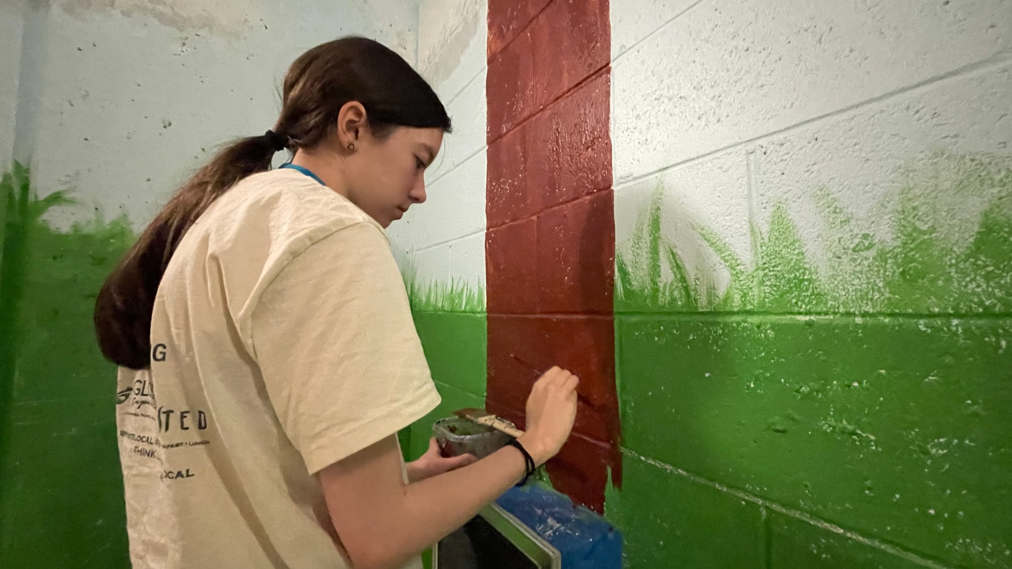 Lia Korpics, a Freedom High School student, paints a tree.