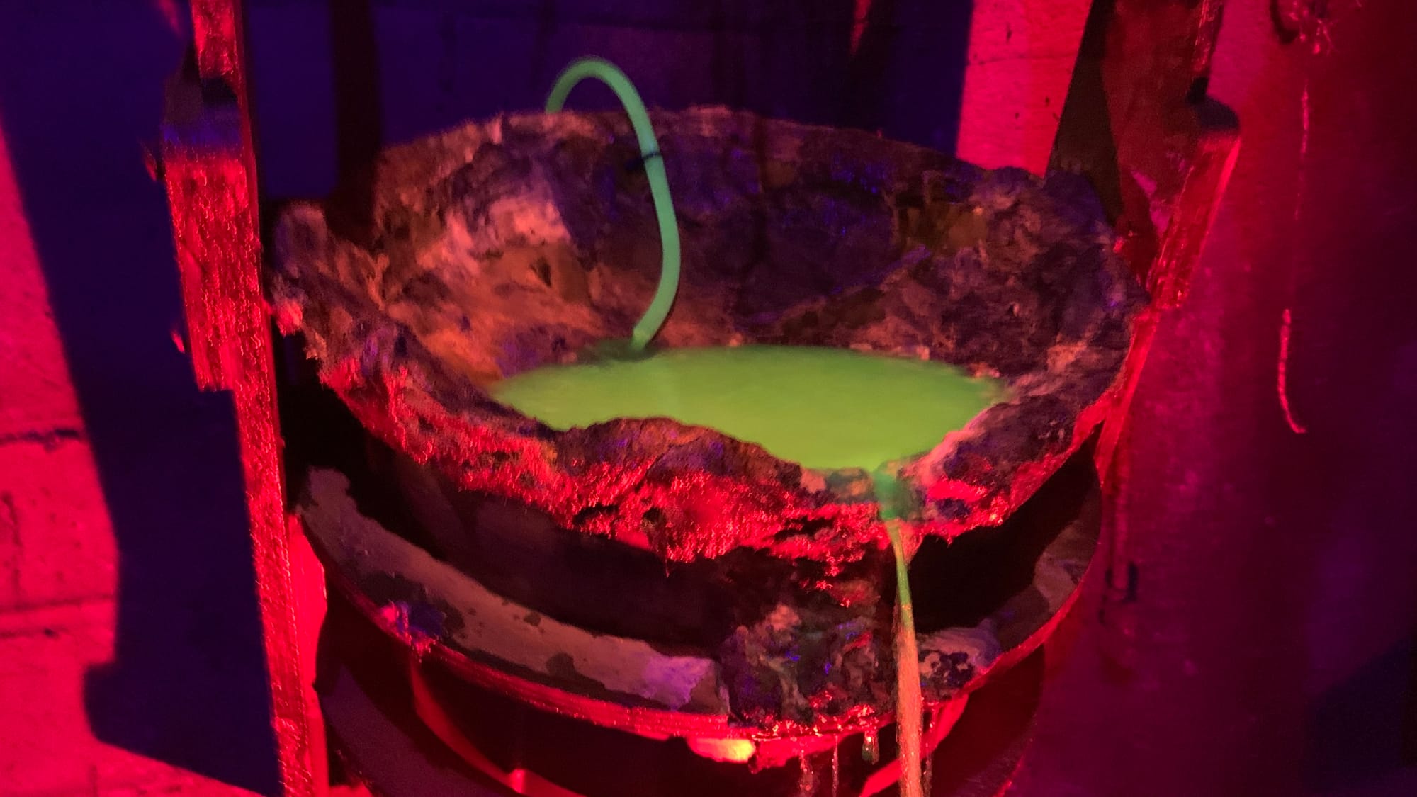 Corrupted steel pours from a bucket in the maze.