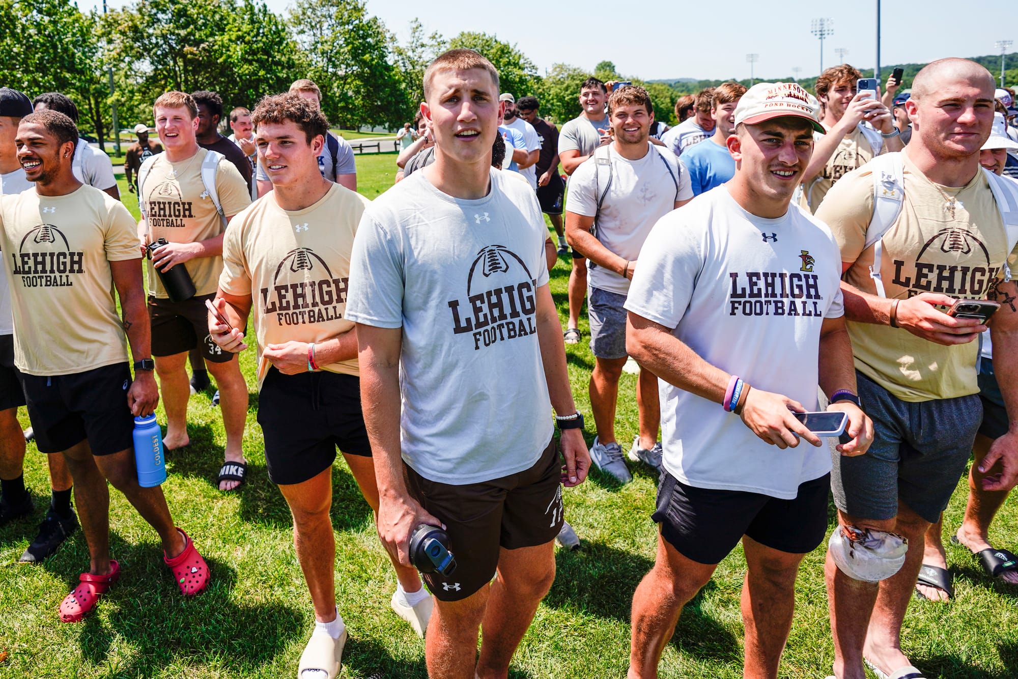 Members of Lehigh's football team watch as U.S. Special Forces members including U.S. Navy SEALs skydive from 4,000' onto the