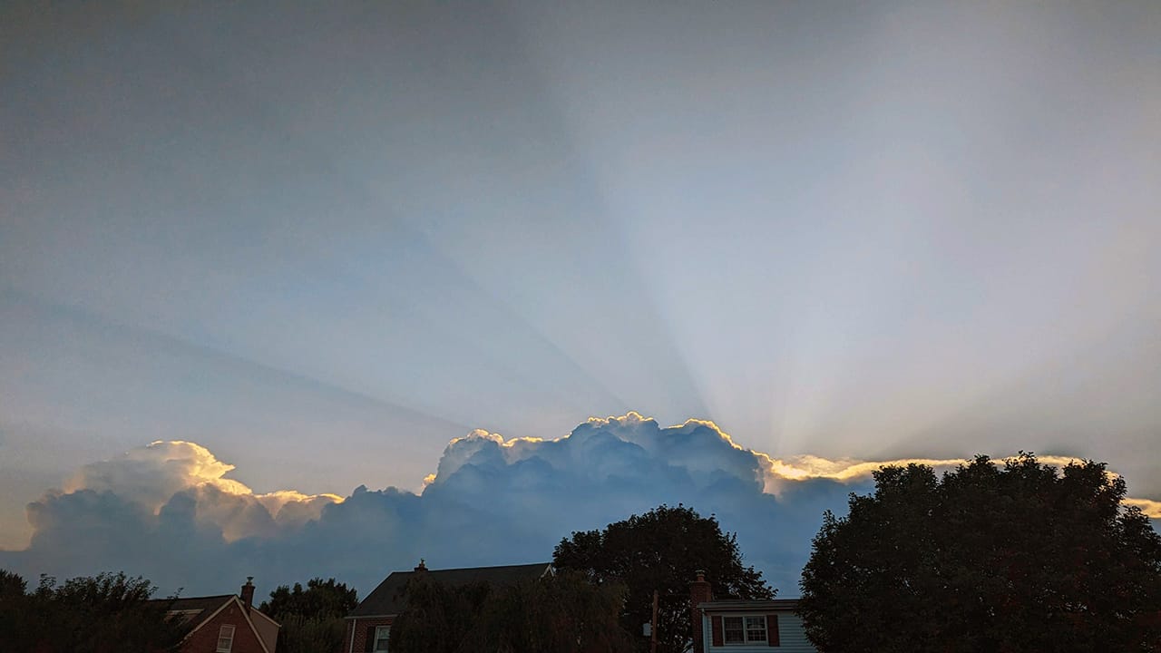 Sunrise through clouds building over Allentown on Friday, July 14, 2023.