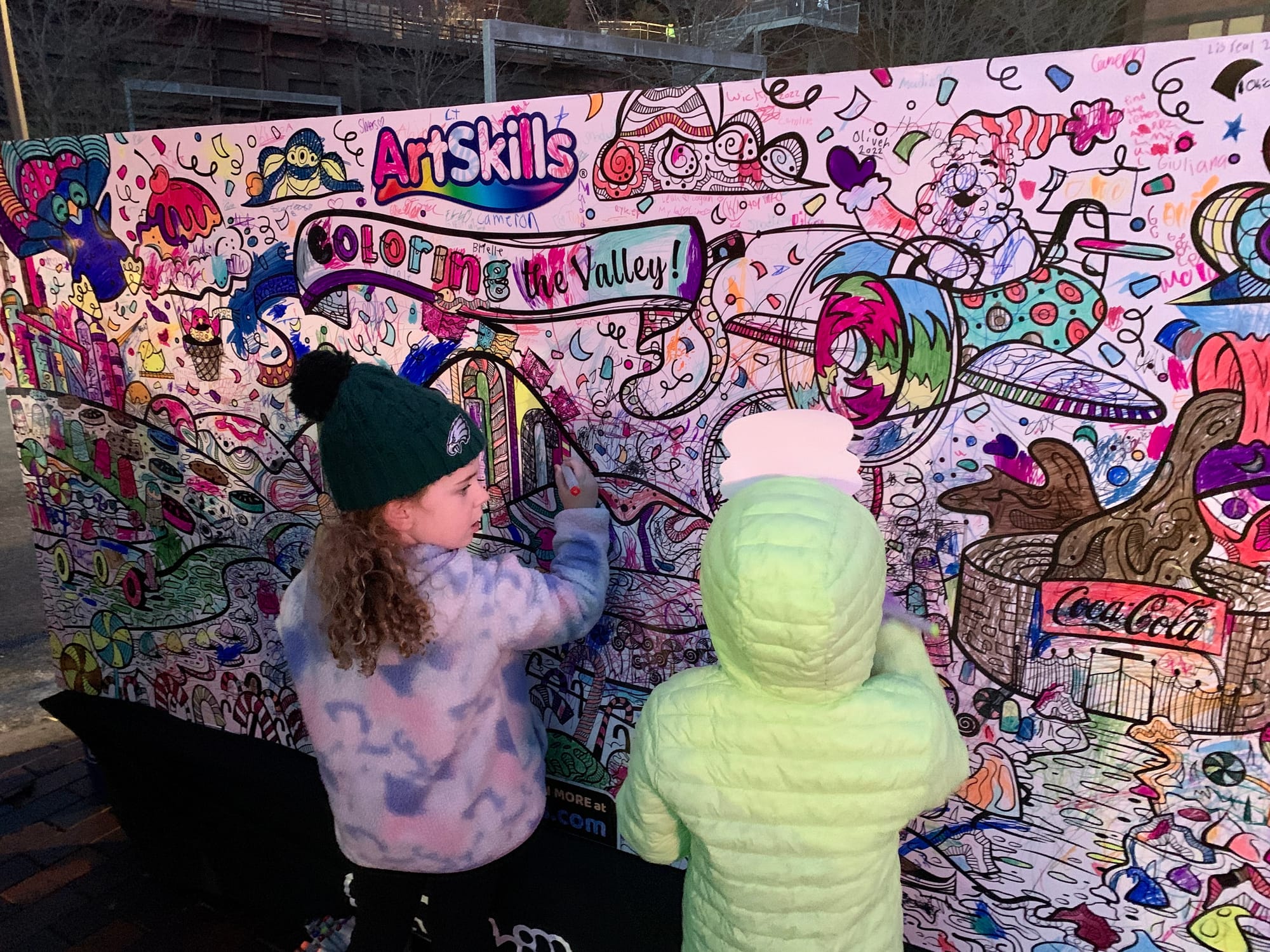 Kids color in the ArtsSkills mural.