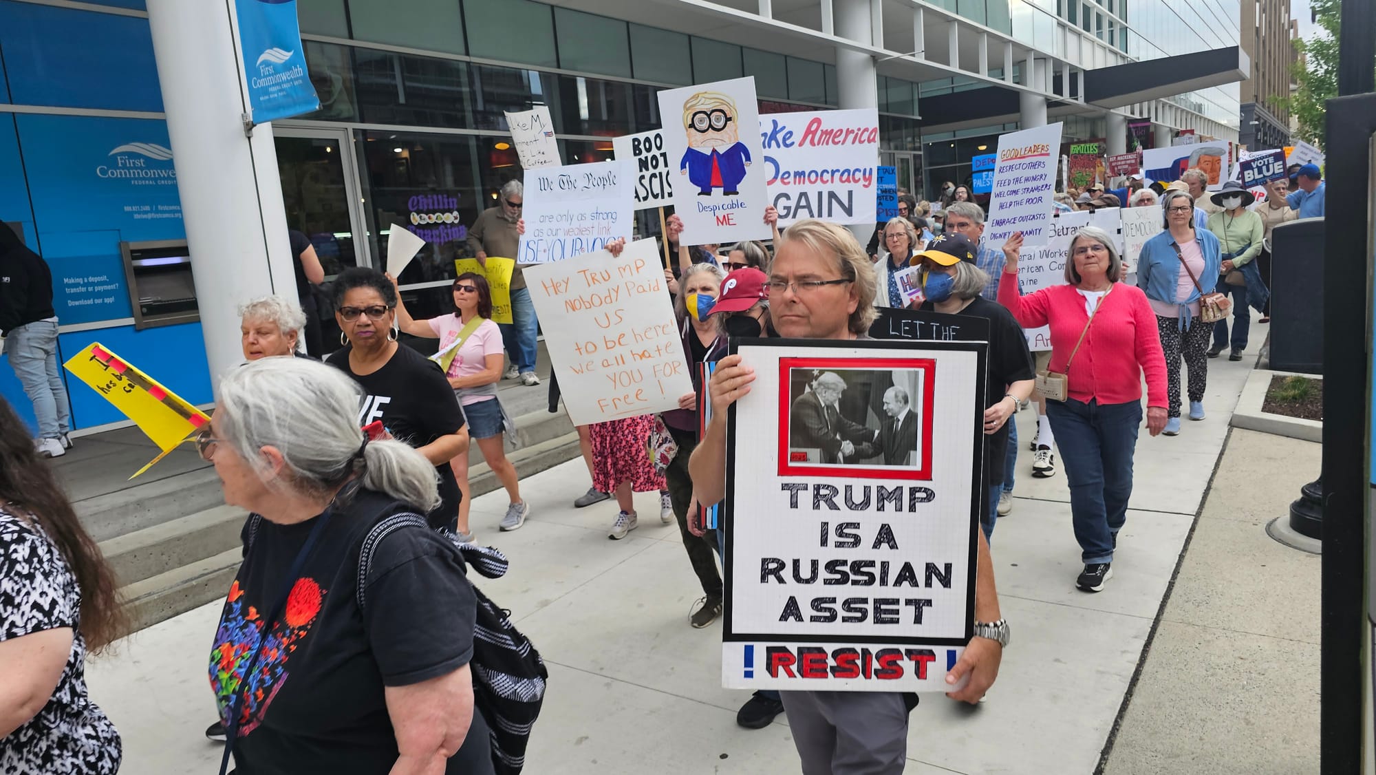 Protesters demonstrate Thursday, May 1, outside the office U.S. Rep. Ryan Mackenzie shares with Sen. Dave McCormick in the Bu