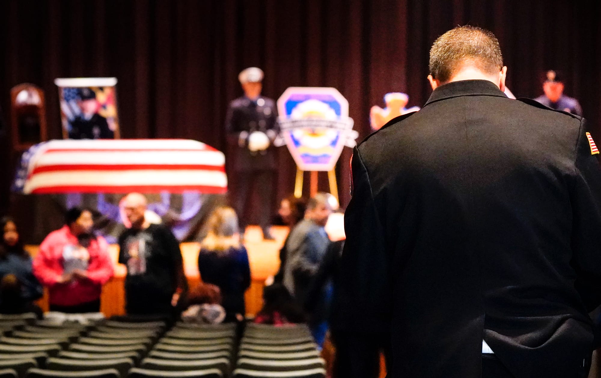 New Tripoli Fire Chief Gary Kuntz, Jr., right, pays respects to his fallen firefighters. Mourners gather at Northwestern Lehi