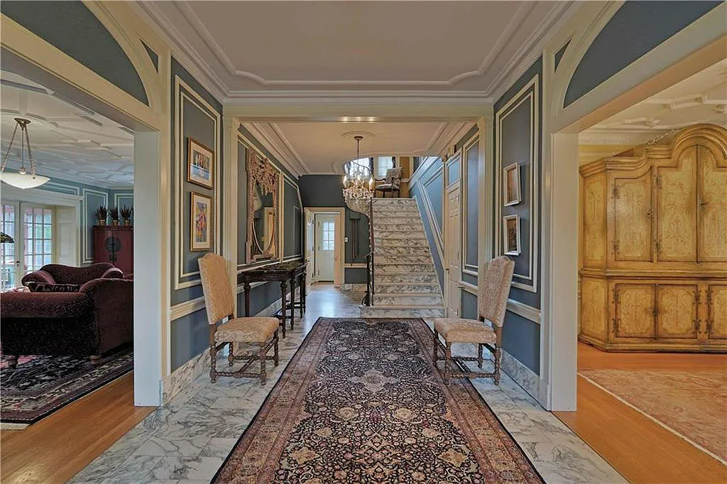 The foyer to this home is made of marble