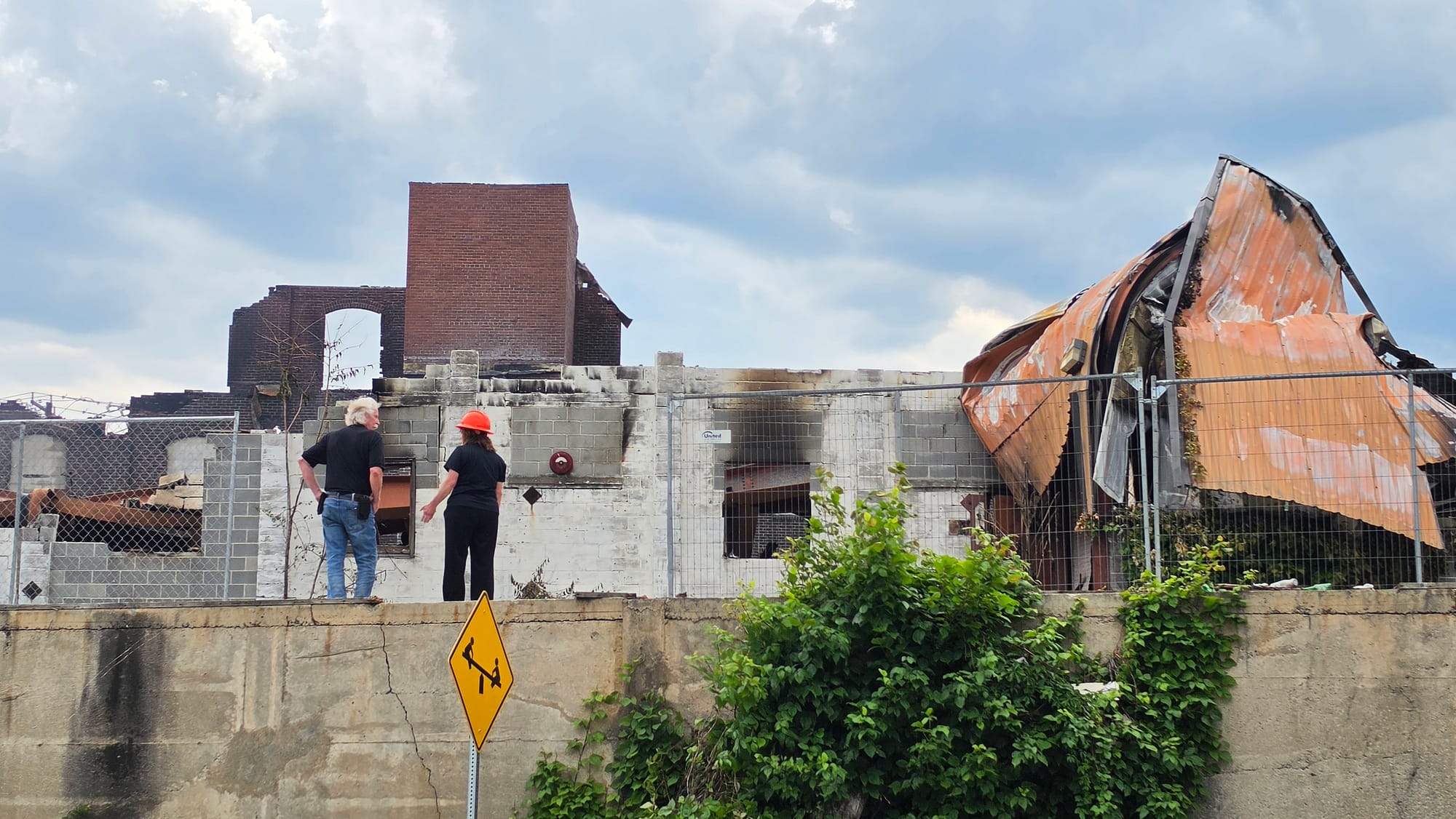 Allentown officials on Thursday, June 25, survey the aftermath of a six-alarm fire that tore through the former American Atel