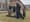 Five people in winter cloths gather around a stone monument to Martin Luther King and his wife Coretta Scott King. It looks like two rounded headstones with a small plaque in the m...