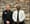  Two men in the uniforms of jail administrators pose for a photo.