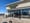 The exterior of a strip mall Starbucks from the outside