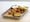 An order of Buffalo chicken wings sits on a counter at a restaurant in San Francisco on Feb. 11, 2022. Party trays of frozen chicken wings are cheaper than last year, according to...